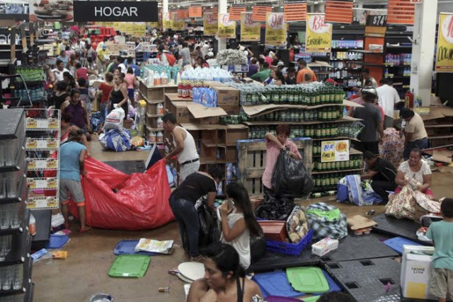 People ransack a store in Veracruz, Mexico, Thursday Jan. 5, 2017. Anger over gasoline price hikes is fueling more protests and looting. Officials say the unrest has resulted in the death of a policeman, the ransacking of hundreds of stores and arrests of hundreds of people. (AP Photo/Felix Marquez)