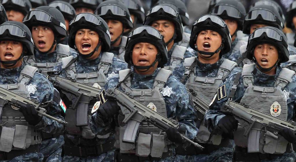 Members of the Gendarmerie Division take part in a parade during its presentation at the headquarters of the Federal Police in Mexico City August 22, 2014. Mexico on Friday launched a scaled-back version of a new police force President Enrique Pena Nieto had vowed to create while on the campaign trail to safeguard businesses against rampant organized crime. Pena Nieto originally promised to create a 40,000-member Gendarmerie Division to take the lead in tackling violent crimes such as extortion and kidnapping, given that poorly paid security forces have been easy targets for the cartels to infiltrate and corrupt. REUTERS/Tomas Bravo (MEXICO - Tags: POLITICS CIVIL UNREST CRIME LAW)